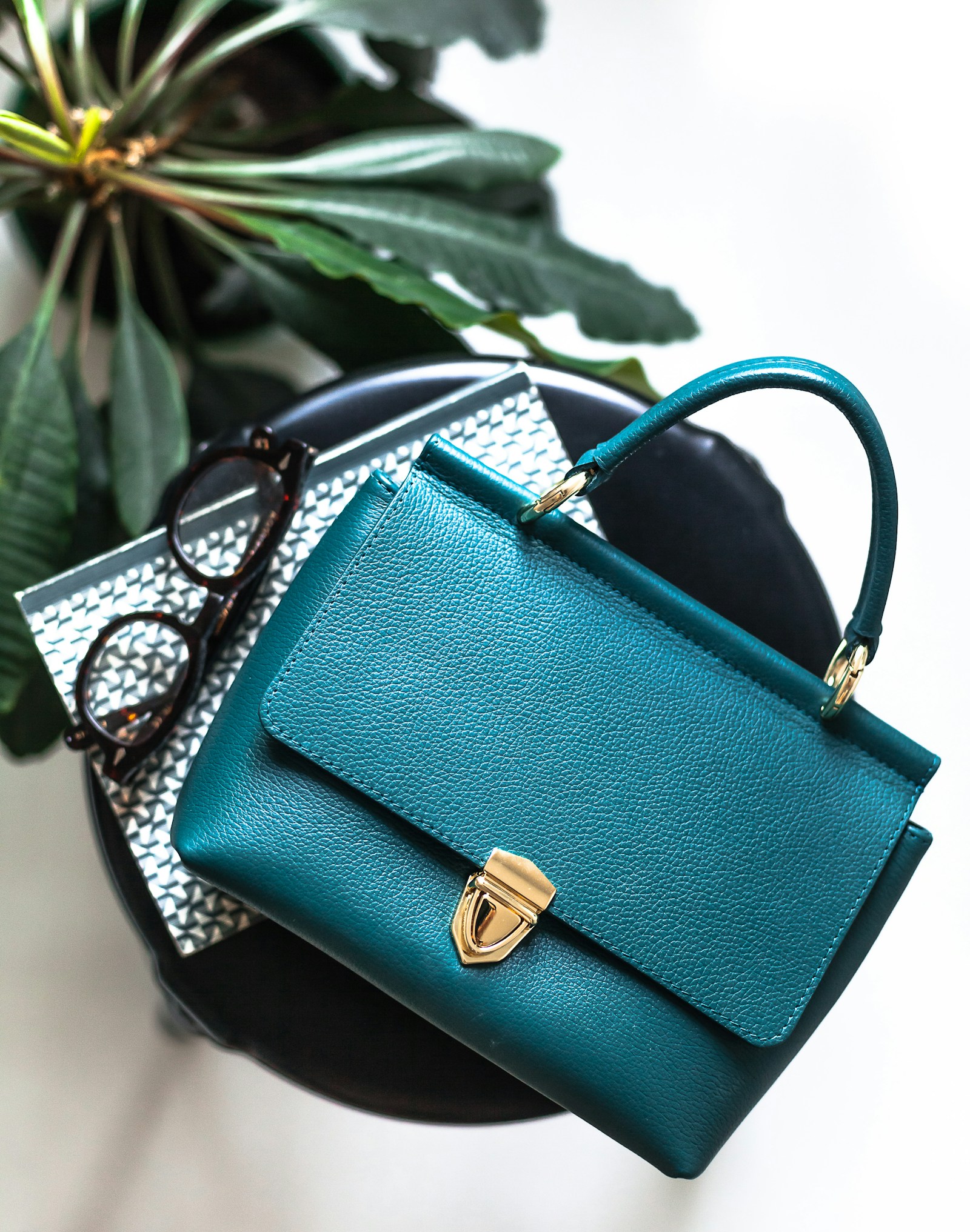 A teal everyday bag styled with accessories